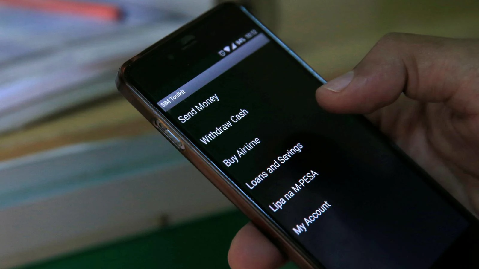 A smartphone showing a fintech app home screen with payments, transport and shopping options