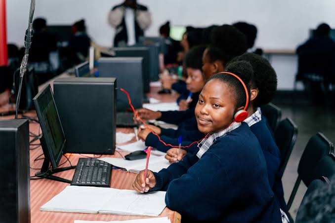 Students and teachers using satellite internet connectivity at a school in Zambia.